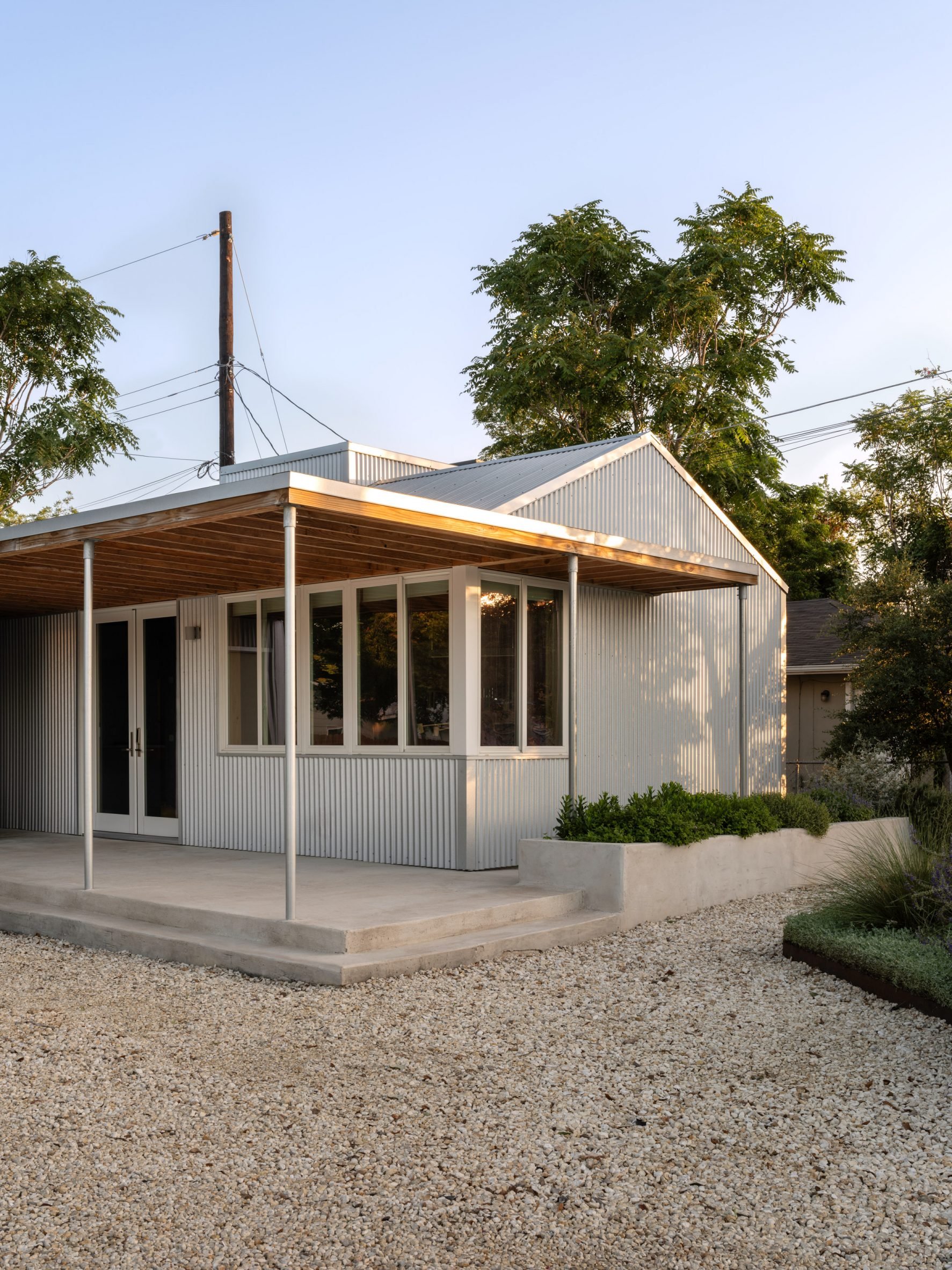 Exterior view of a gabled building with a large canopy and metal cladding